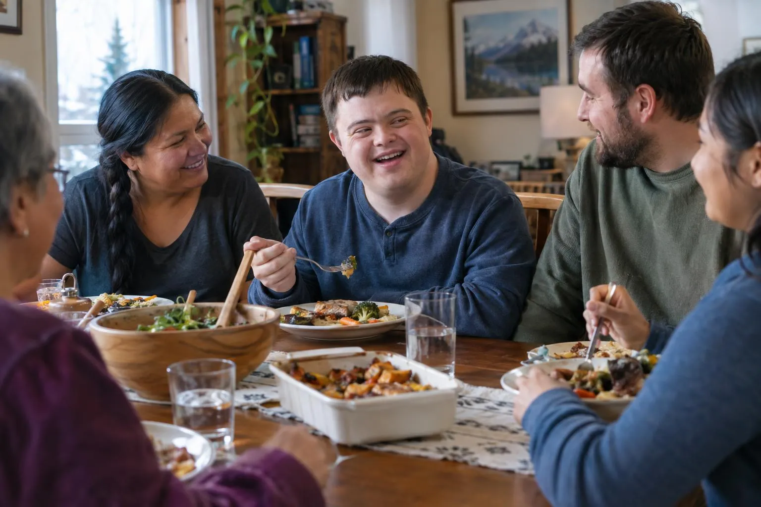 A young man shares dinner with his host family around the table.